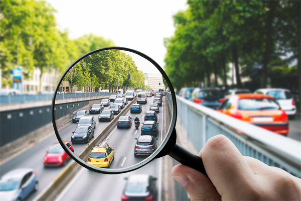 Magnifying glass looking at cars