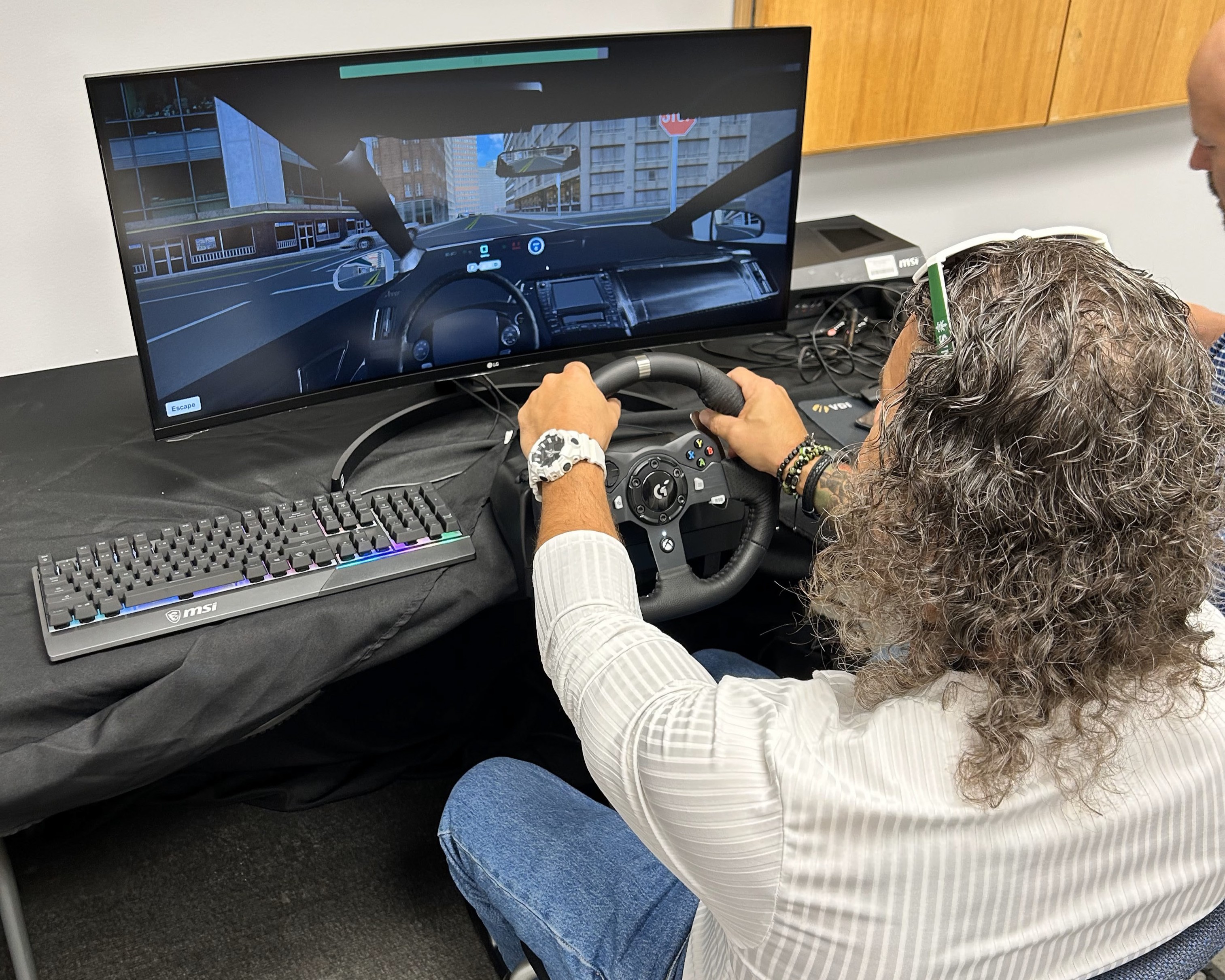 Woman sitting at a driving simulator
