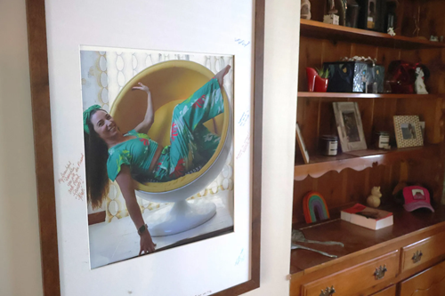 Framed picture of a woman on a shelf