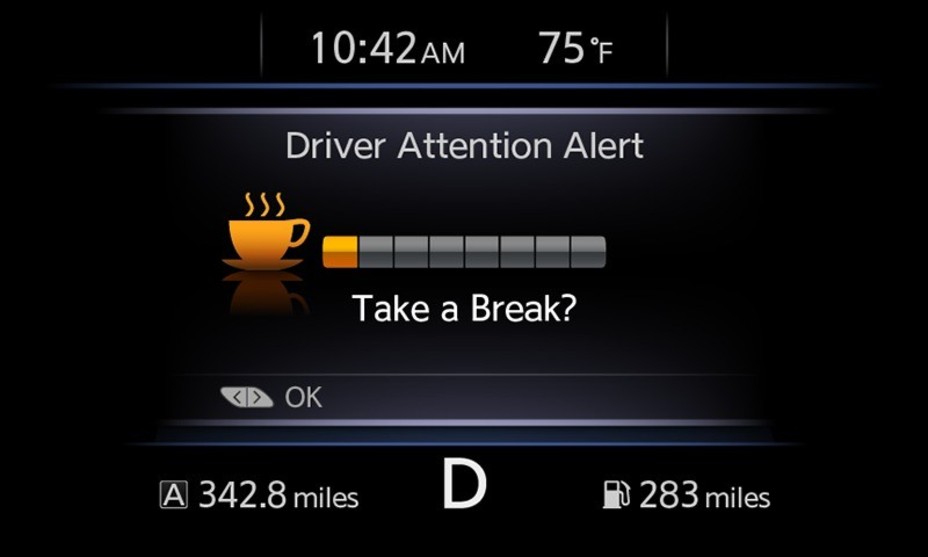 Vehicle dashboard warning saying "driver attention alert" 