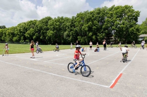 Kids riding bikes in a parking lot
