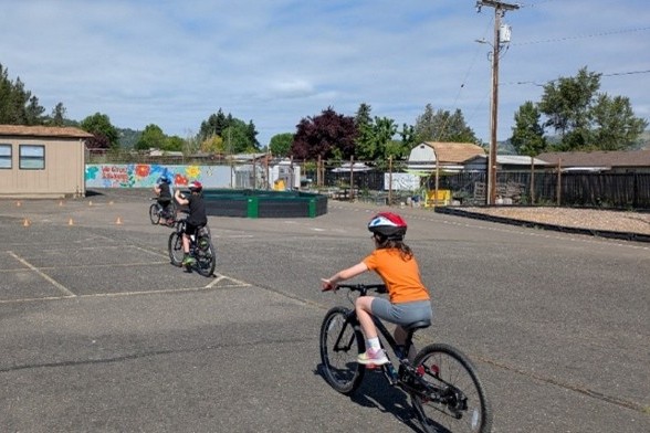 Kids riding bikes in a parking lot