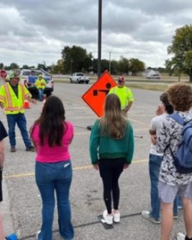 Teens watching a roadway safety demonstration