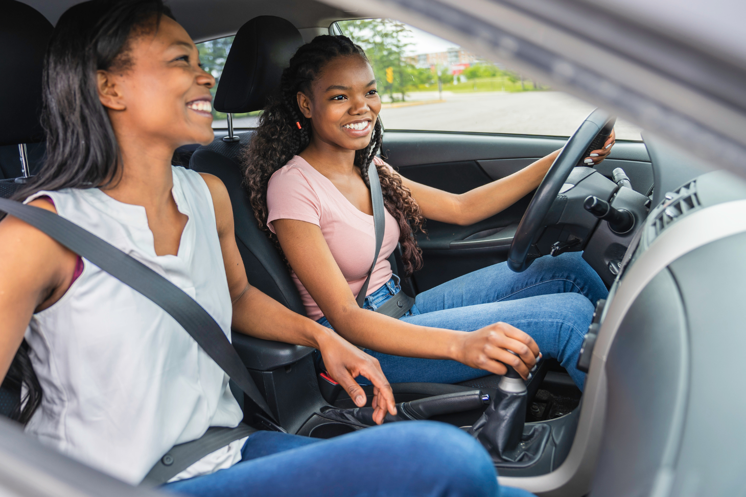 Image of a teen driving a car with her mother in the front passenger seat