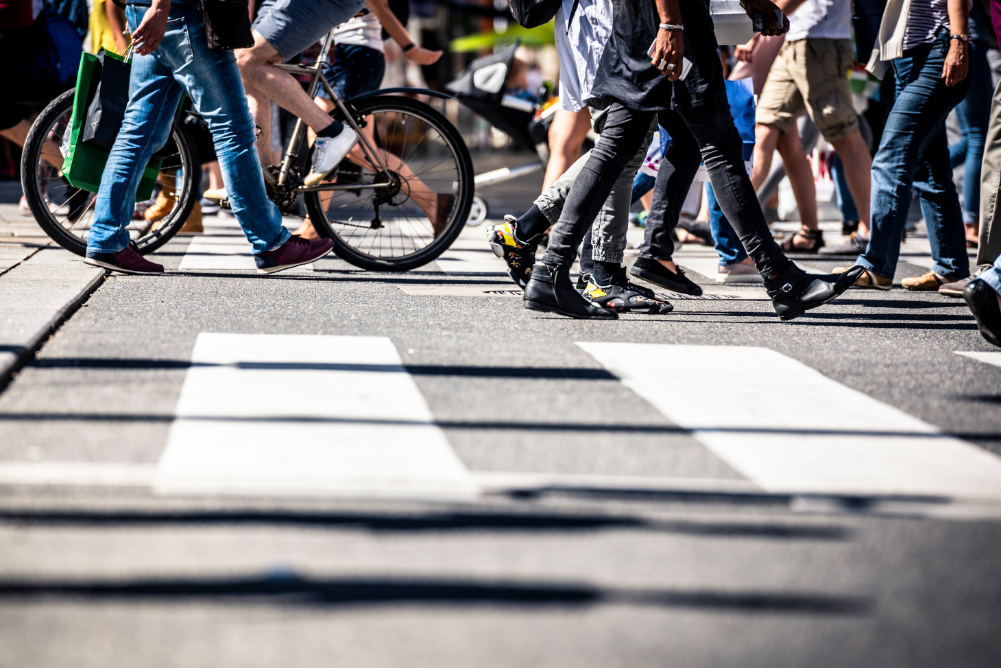 View of pedestrians and bicyclists crossing the street in a crosswalk
